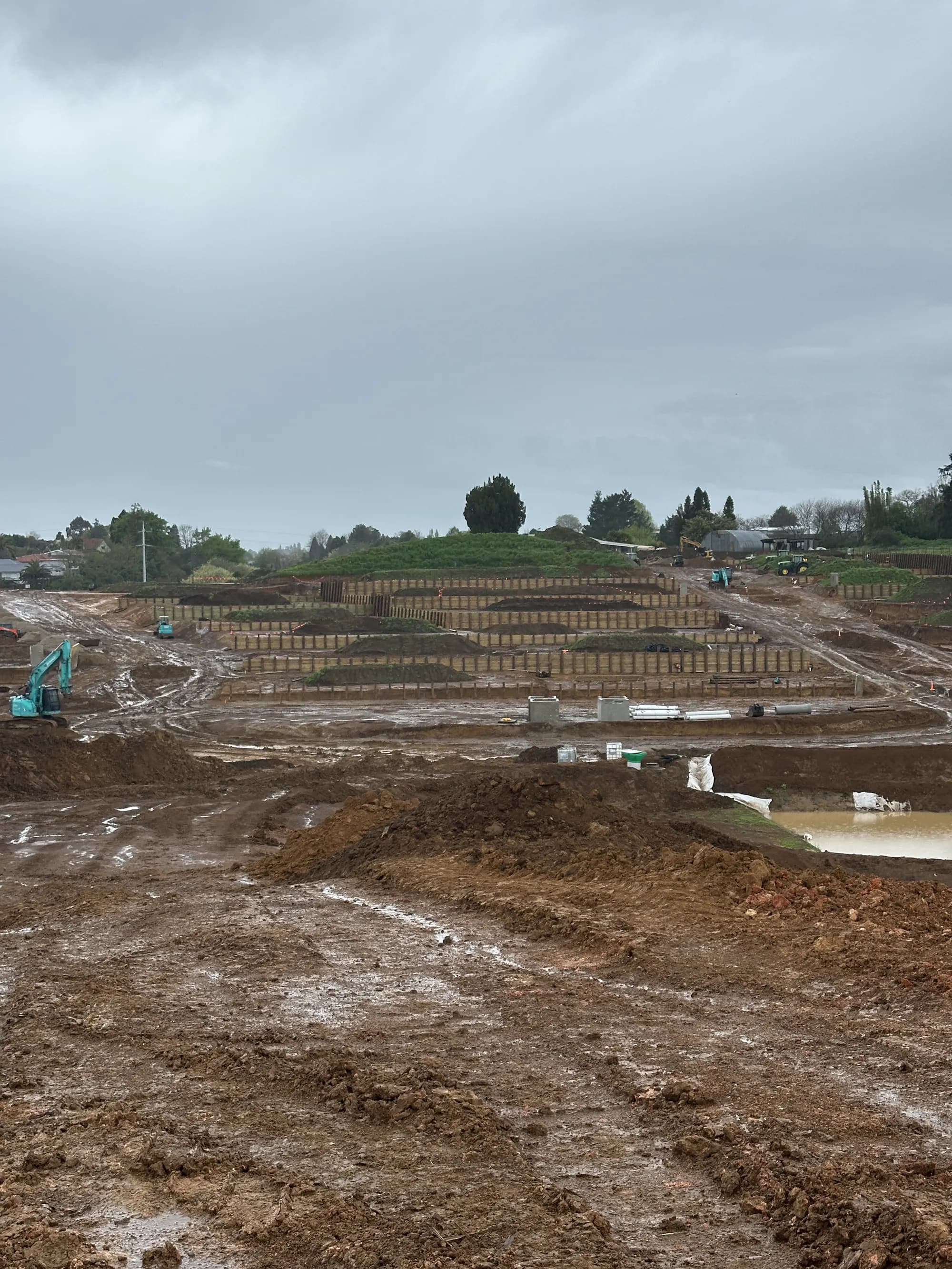 Retaining walls and formed terraces across the Parkview site on a wet winter day
